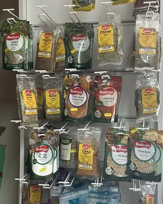 A hanging stand of Bodrum herb and spice packets: mint, chives, basil, paprika, pine nuts